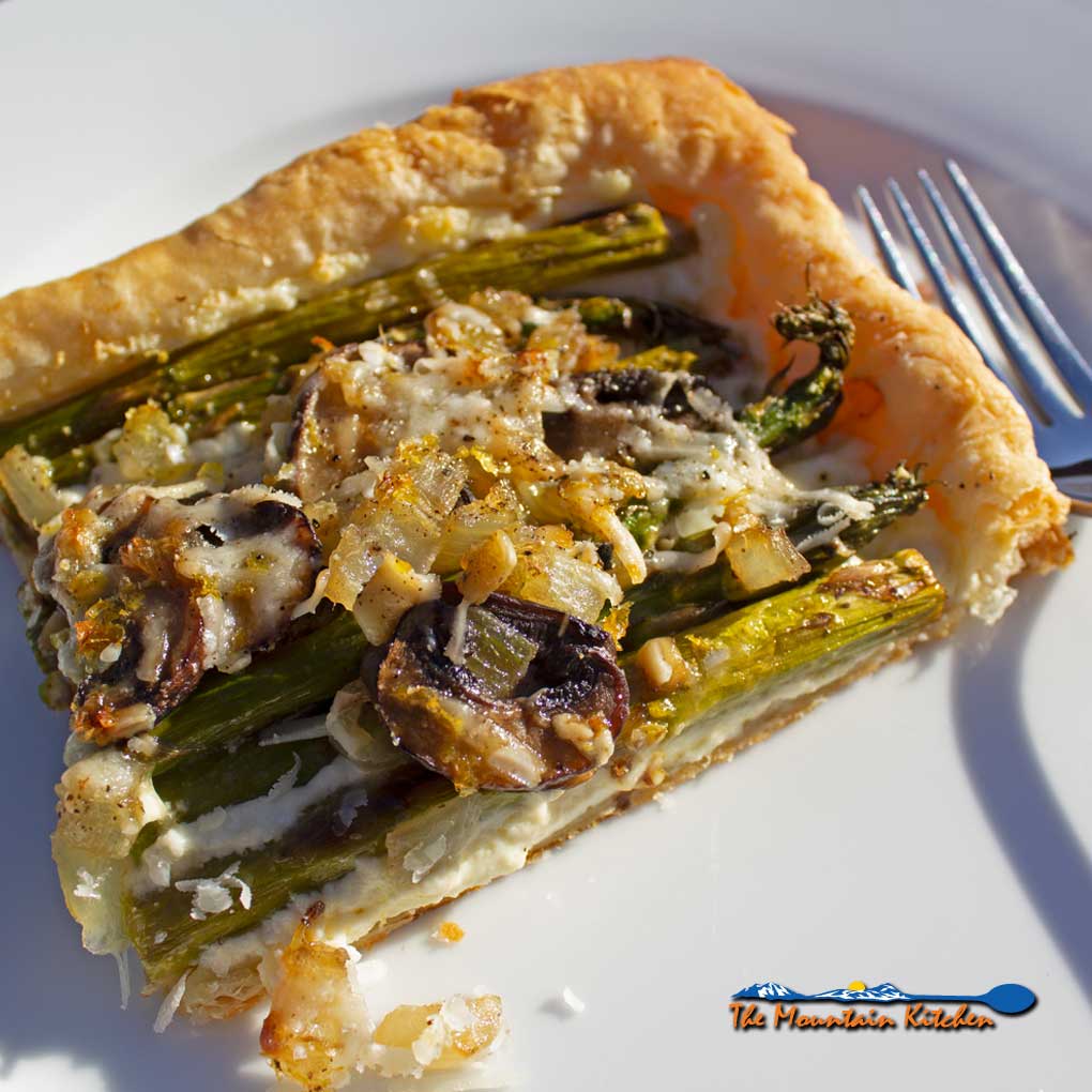 asparagus ricotta tart on plate ready to eat