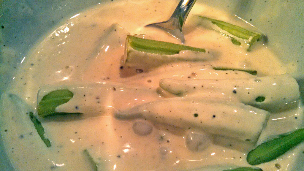 dredging fresh okra in batter