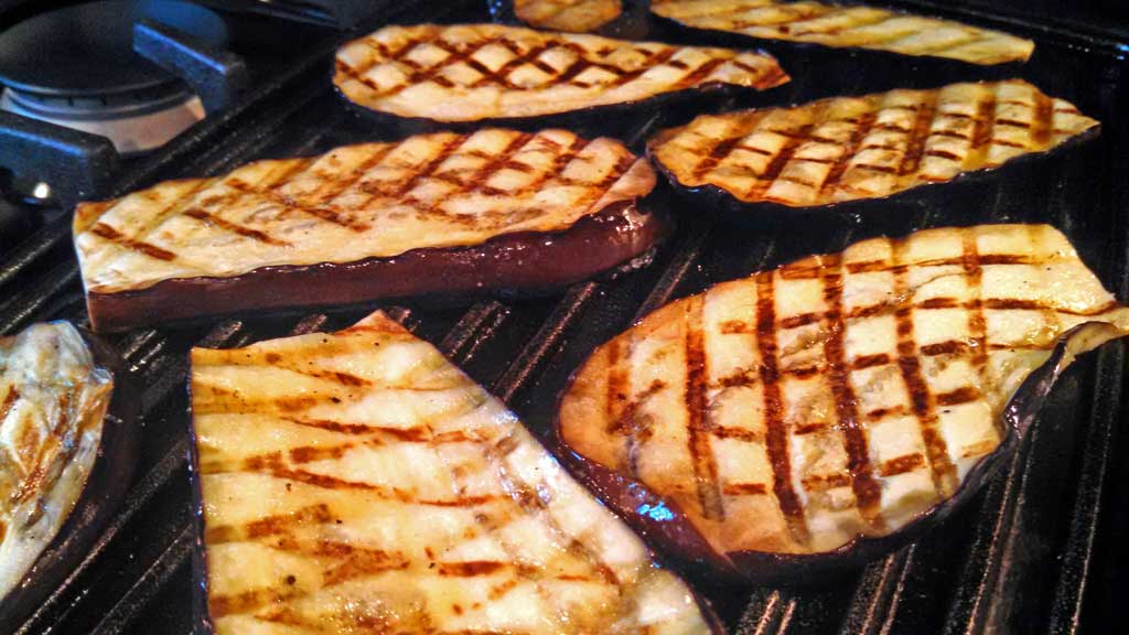 These grilled eggplant slices are salted to eliminate the bitterness. Brushed with garlic, olive oil and seasoned with salt and pepper and grilled. | TheMountainKitchen.com