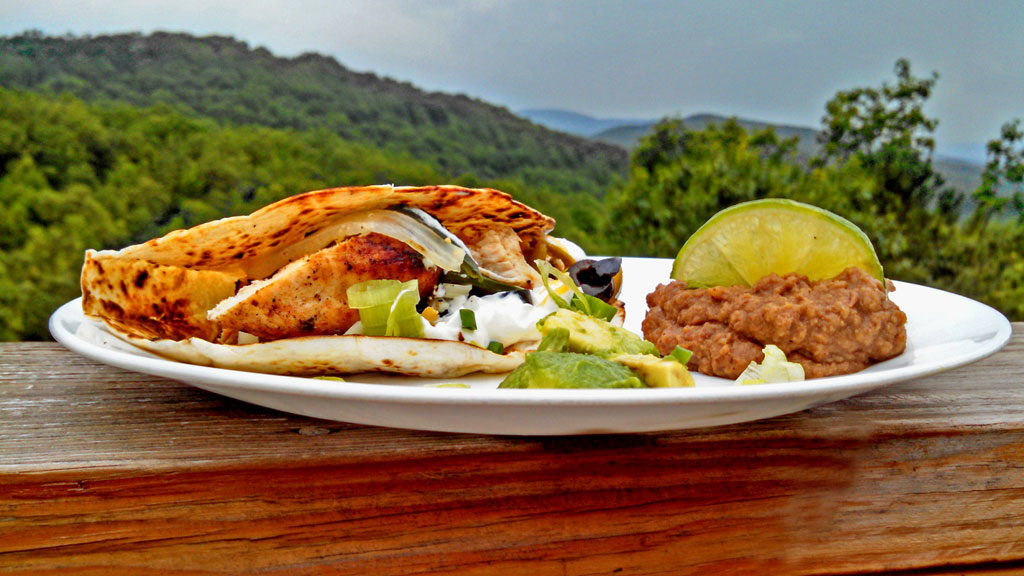 Grilled tequila-lime chicken fajitas: chicken breasts marinated in Mexican flavors, grilled, and placed inside a toasted tortilla with unlimited toppings. | TheMountainKitchen.com