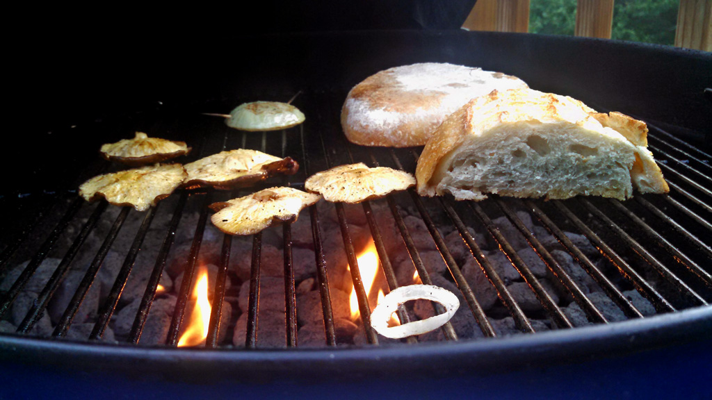 Summer squash, eggplant, zucchini, bell pepper, mushrooms and tomatoes all grilled to make a warm grilled vegetable salad with bread and dressing. | TheMountainKitchen.com