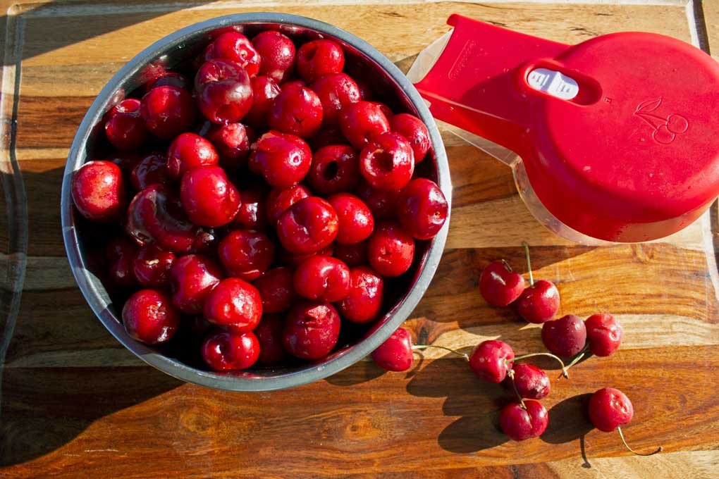 bowl of cherries with pitter
