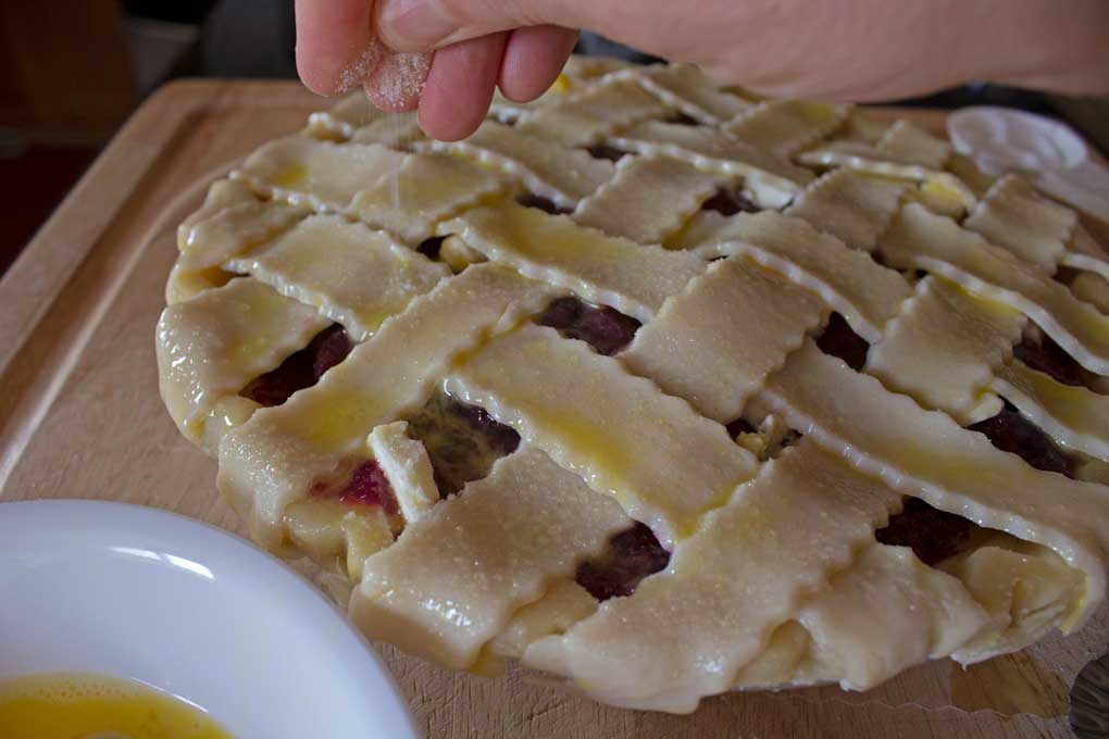 sprinkling sugar onto crust