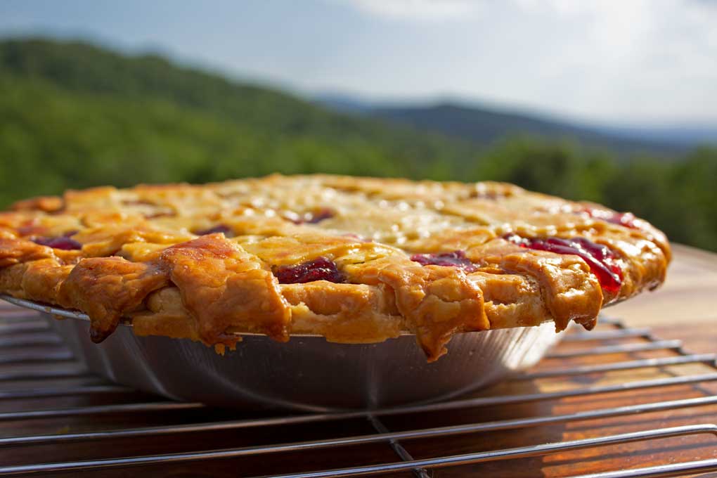 homemade cherry pie with mountain view