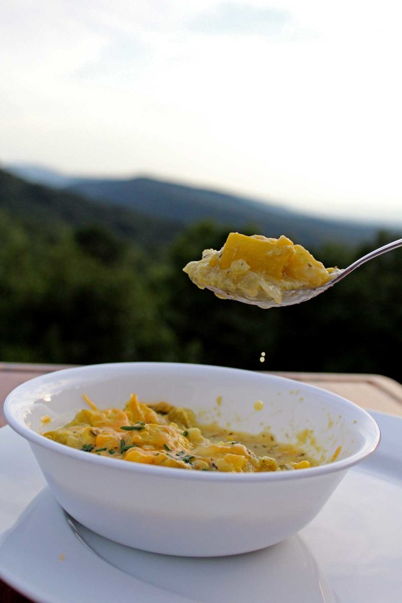 a spoon full of corn chowder with mountain view