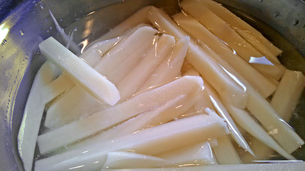 cut potatoes soaking in water