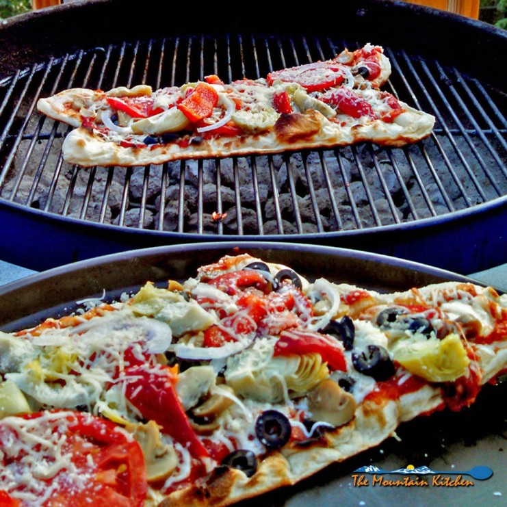 Grilled veggie pizzas on charcoal grill