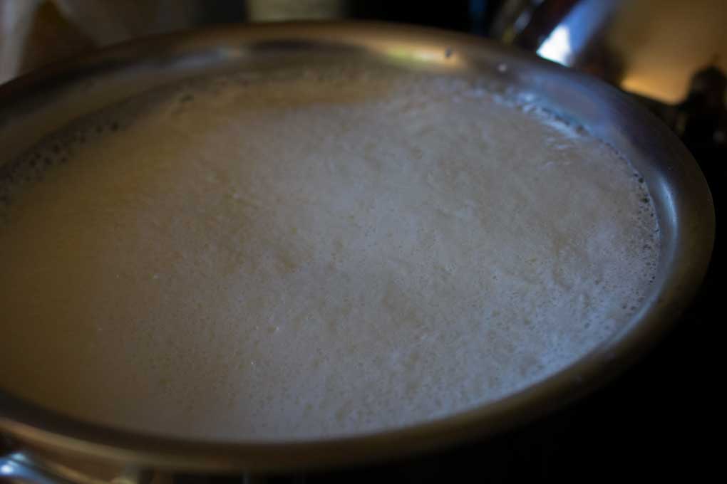 curds and whey separating in pot