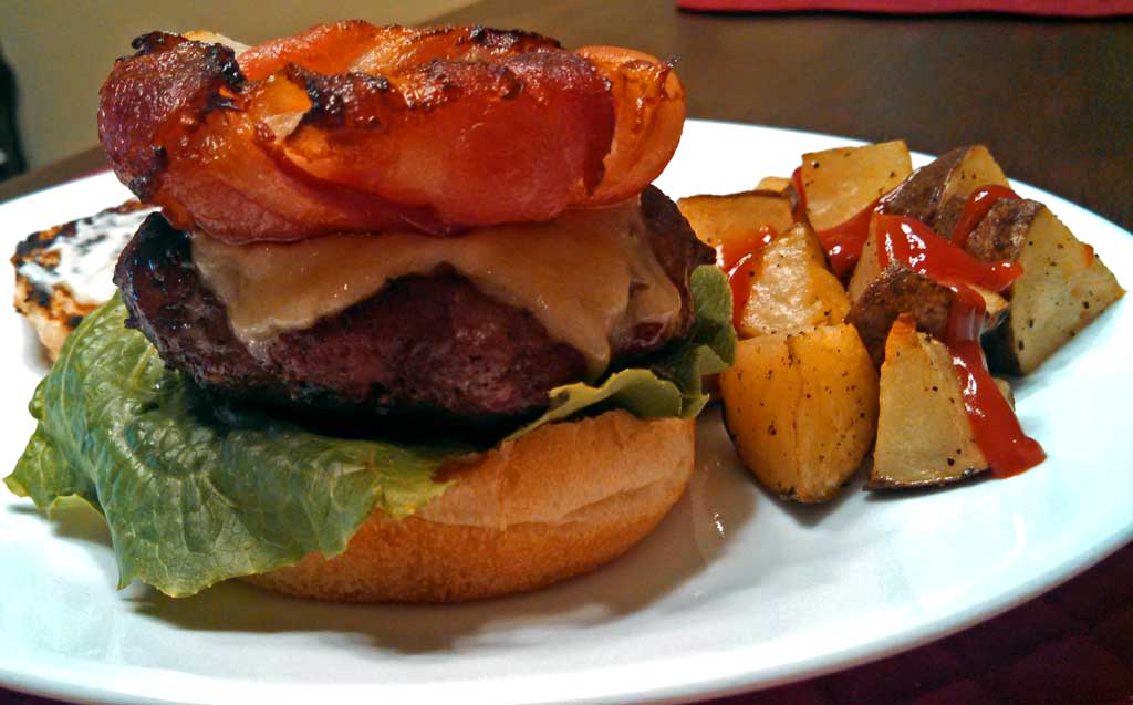 Bacon Onion Burger Crowns ~ Slices of crispy, smokey bacon wrapped around sweet onion rings grilled or baked to make the perfect crown for your next burger. | TheMountainKitchen.com