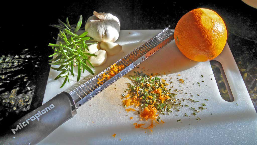 Beer Can Chicken is flavored with rosemary garlic orange butter sauce with garlic, slow cooked on the grill until tender, moist and falling-off-the-bone. | TheMountainKitchen.com