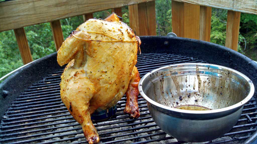 Beer Can Chicken is flavored with rosemary garlic orange butter sauce with garlic, slow cooked on the grill until tender, moist and falling-off-the-bone. | TheMountainKitchen.com