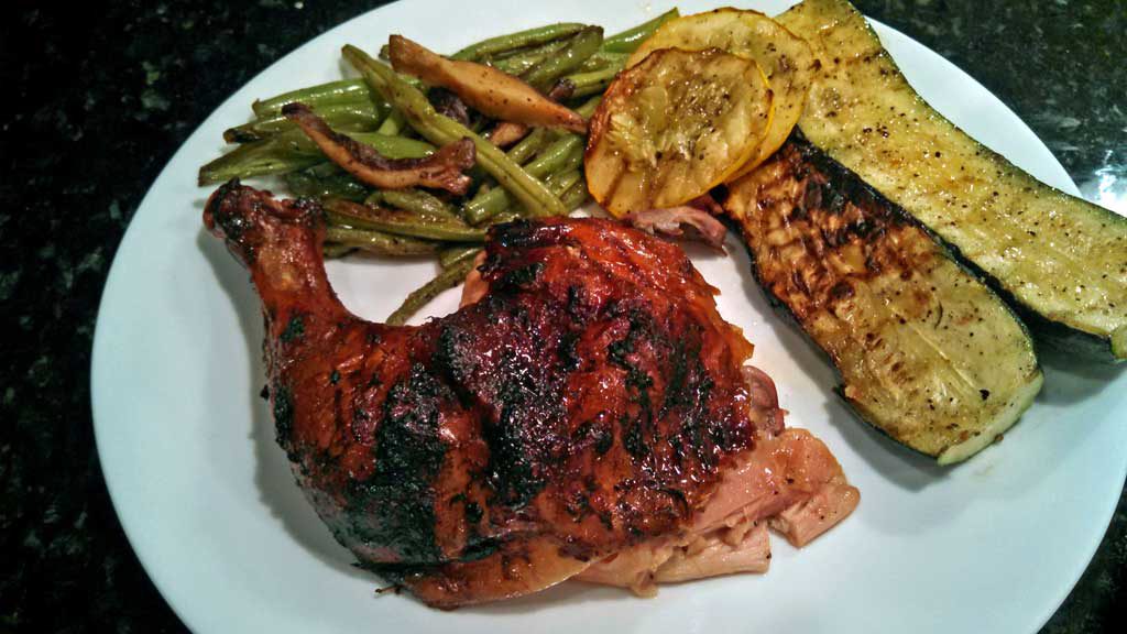 Beer Can Chicken is flavored with rosemary garlic orange butter sauce with garlic, slow cooked on the grill until tender, moist and falling-off-the-bone. | TheMountainKitchen.com