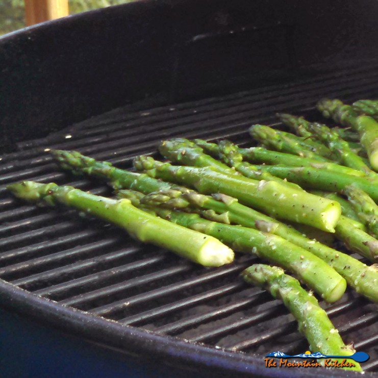 These grilled asparagus are seasoned with salt & pepper, olive oil and lemon zest. Grilled until slightly charred and tender, topped with Parmesan cheese. | TheMountainKitchen.com