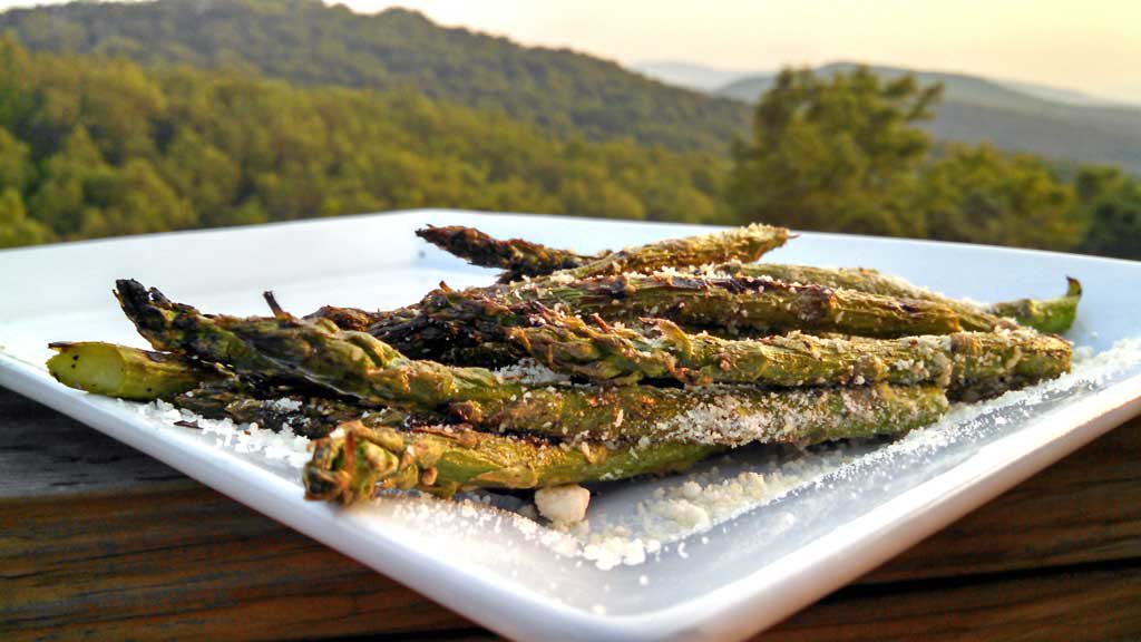 These grilled asparagus are seasoned with salt & pepper, olive oil and lemon zest. Grilled until slightly charred and tender, topped with Parmesan cheese. | TheMountainKitchen.com