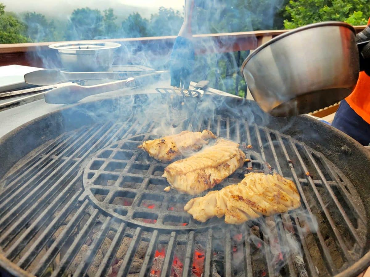 grilling fish with pot over top