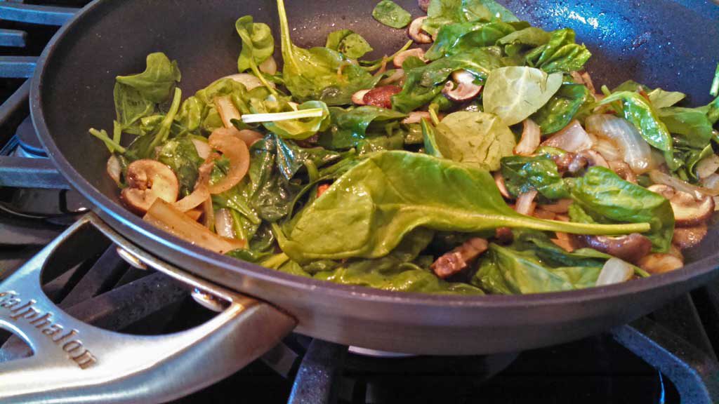 mushrooms and spinach in skillet
