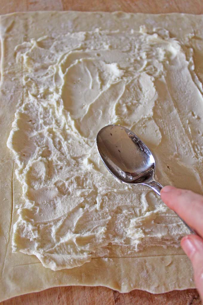 spreading ricotta cheese with spoon