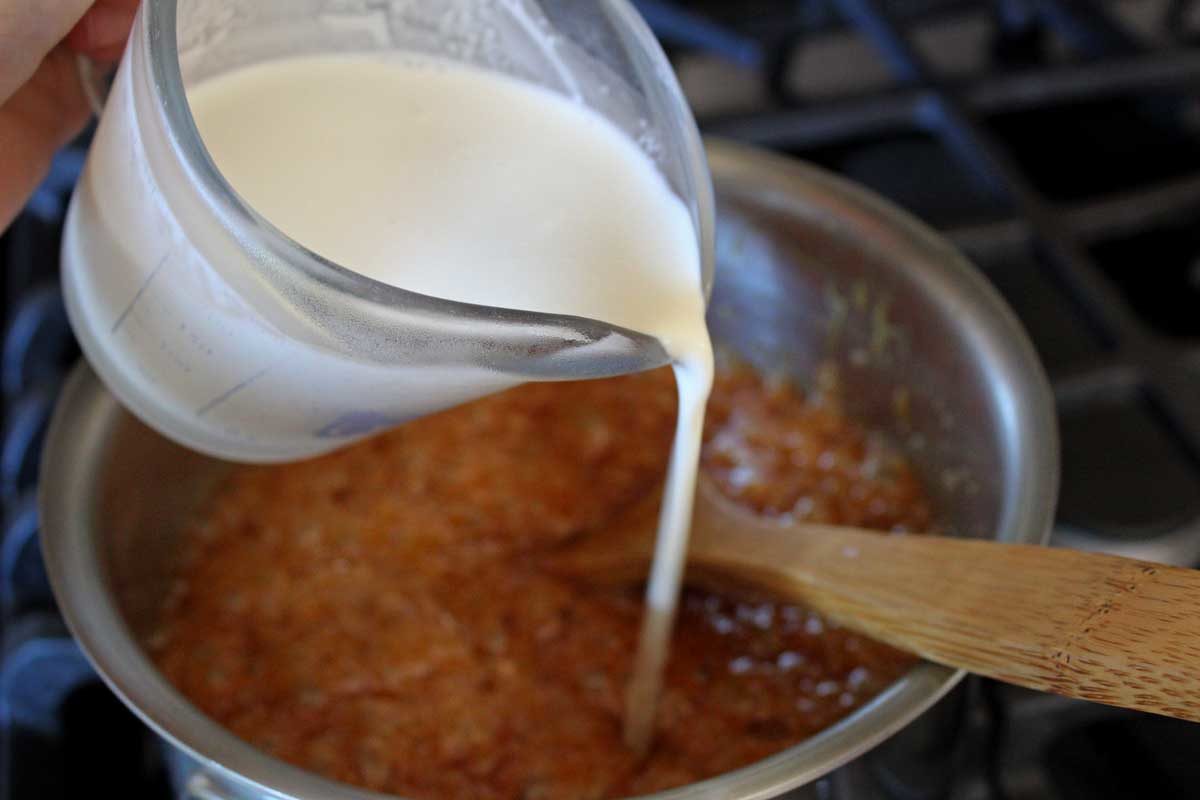 pouring cream into saucepan