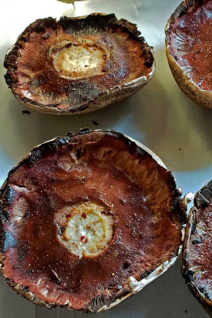 prepped mushroom caps on sheet pan