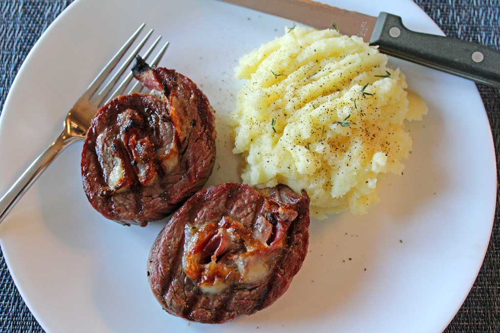 Grilled stuffed flank steak is a juicy steak rolled into a pinwheel with rich garlicky Italian meat, cheese and herbs, on a skewer. Italian Meat Lollipops! | TheMountainKitchen.com