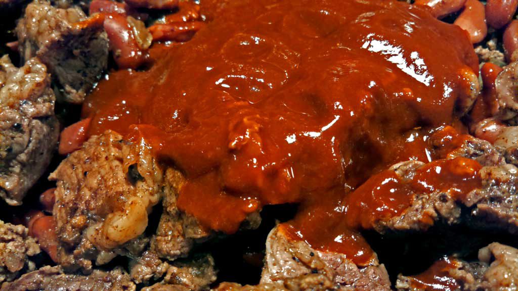 Our slow cooker chili is made in a crock-pot with chunks steak and ground beef, beans, tomatoes, fresh chili sauce and even some coffee for extra richness. | TheMountainKitchen.com
