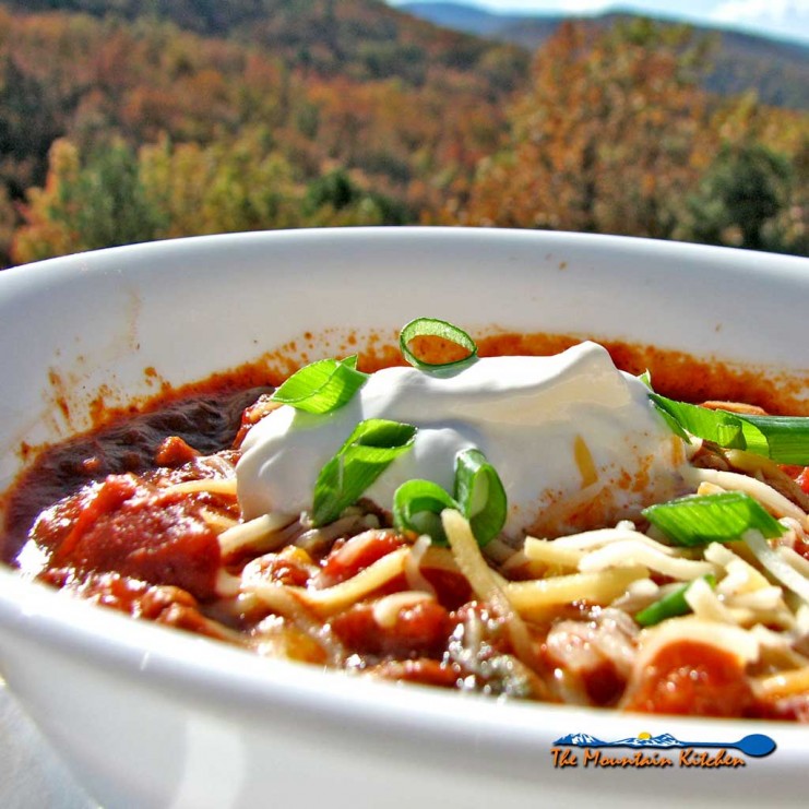 Our slow cooker chili is made in a crock-pot with chunks steak and ground beef, beans, tomatoes, fresh chili sauce and even some coffee for extra richness. | TheMountainKitchen.com