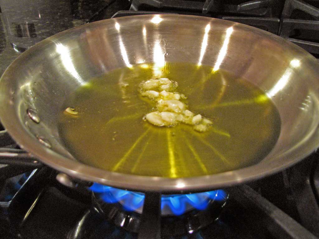 garlic in pan filled with oil