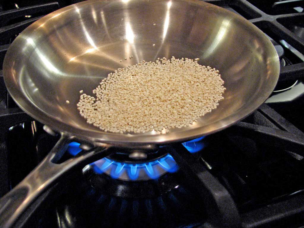 toasting sesame seeds in a pan
