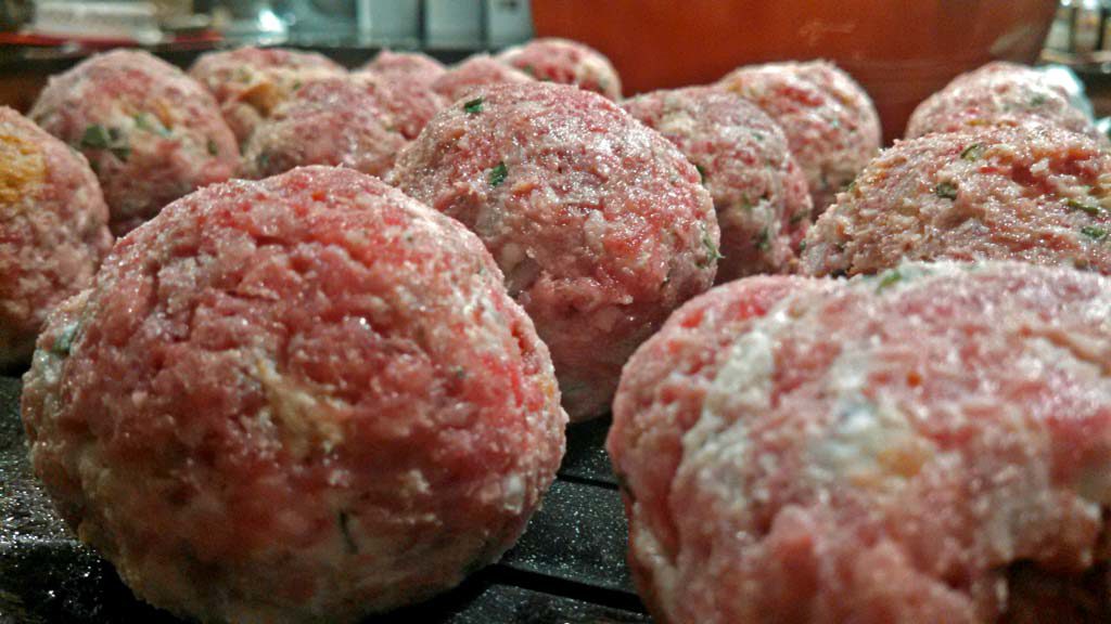 raw meatballs ready to bake