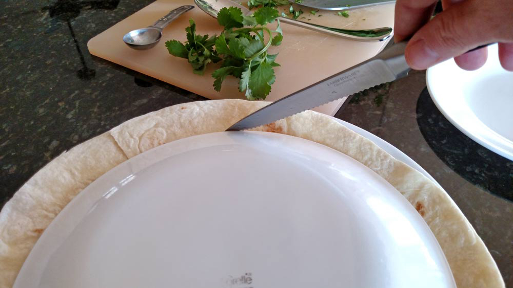 knife slicing around edge of plate