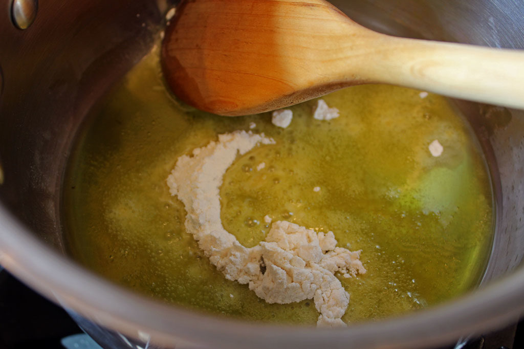 stirring flour into pot with oil