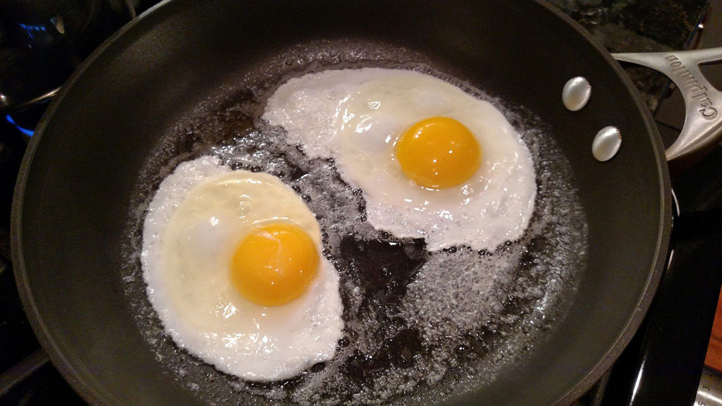 frying eggs in a pan