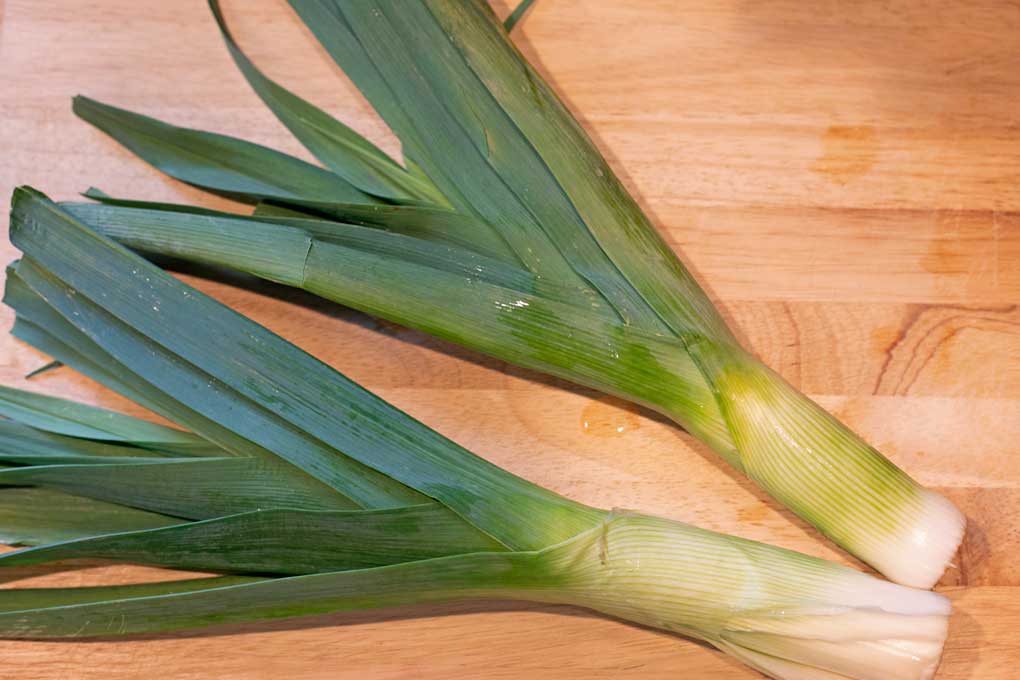 leeks laying on cutting board