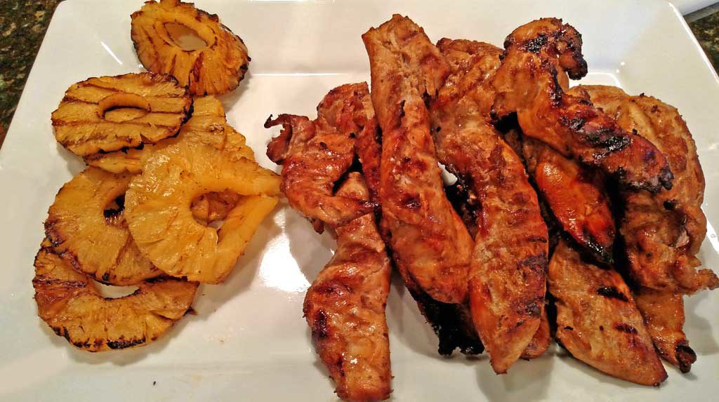 Grilled juicy chicken and pineapple slices with slaw and cashews rolled up in a sandwich wrap to make Asian Chicken Wraps. A great spring grilling recipe! | TheMountainKitchen.com