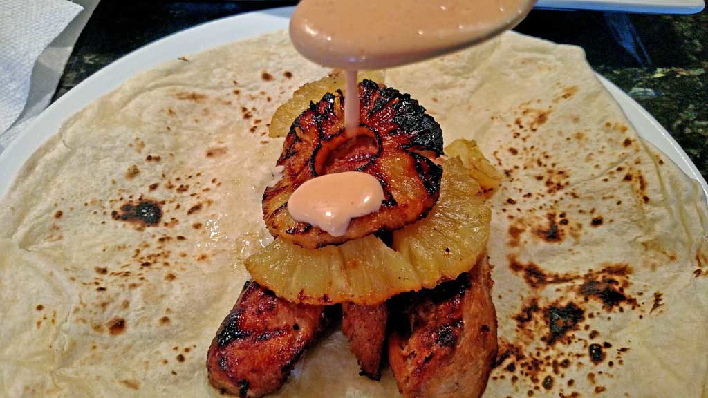 Grilled juicy chicken and pineapple slices with slaw and cashews rolled up in a sandwich wrap to make Asian Chicken Wraps. A great spring grilling recipe! | TheMountainKitchen.com