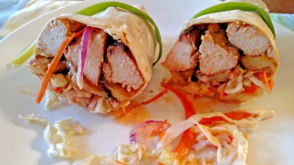 Grilled juicy chicken and pineapple slices with slaw and cashews rolled up in a sandwich wrap to make Asian Chicken Wraps. A great spring grilling recipe! | TheMountainKitchen.com