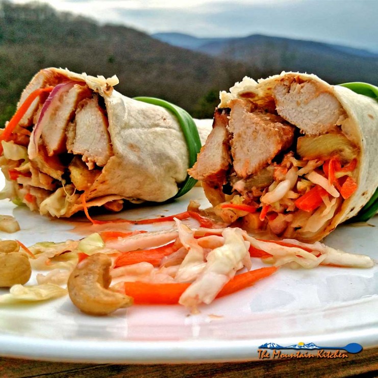 Grilled juicy chicken and pineapple slices with slaw and cashews rolled up in a sandwich wrap to make Asian Chicken Wraps. A great spring grilling recipe! | TheMountainKitchen.com