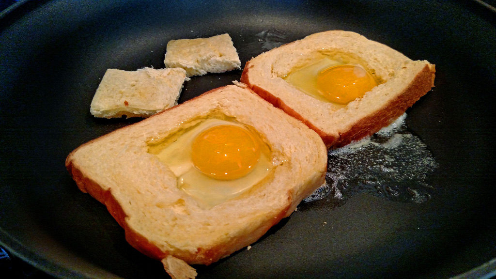 Eggs in a basket is a quick and easy breakfast, these eggs are fried inside a hole cut into a slice of bread and topped with melted cheese. | TheMountainKitchen.com