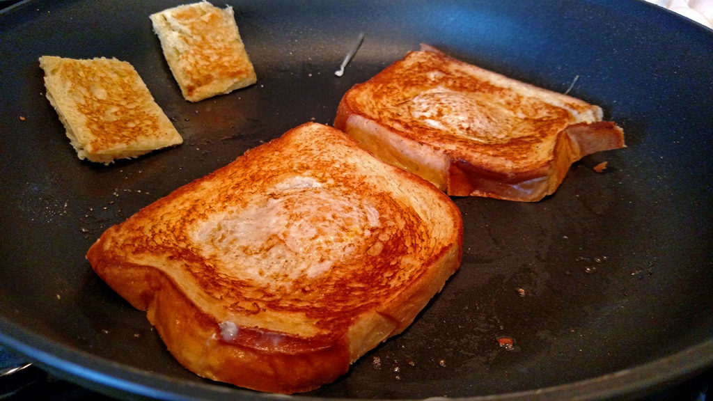 Eggs in a basket is a quick and easy breakfast, these eggs are fried inside a hole cut into a slice of bread and topped with melted cheese. | TheMountainKitchen.com