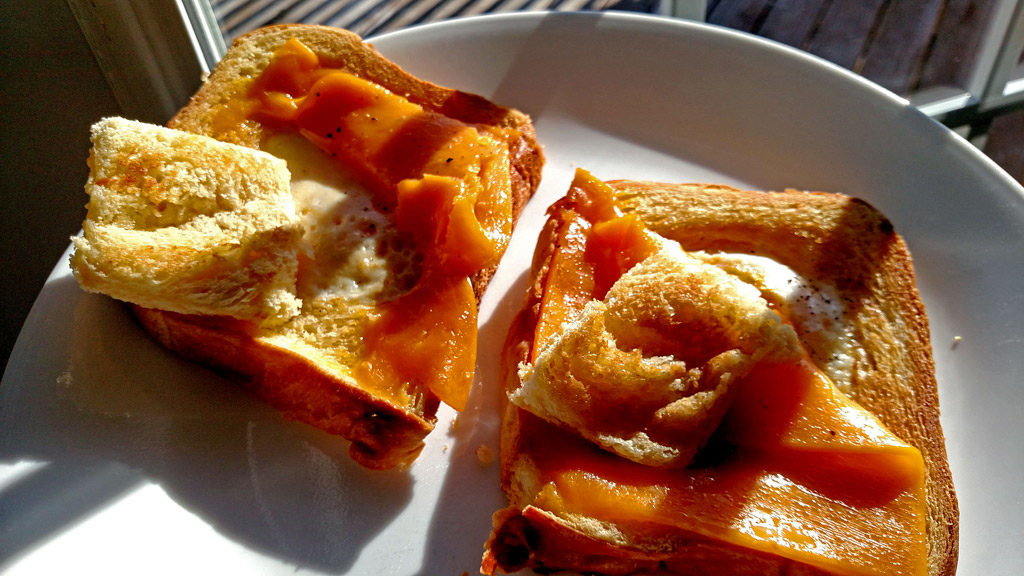 Eggs in a basket is a quick and easy breakfast, these eggs are fried inside a hole cut into a slice of bread and topped with melted cheese. | TheMountainKitchen.com