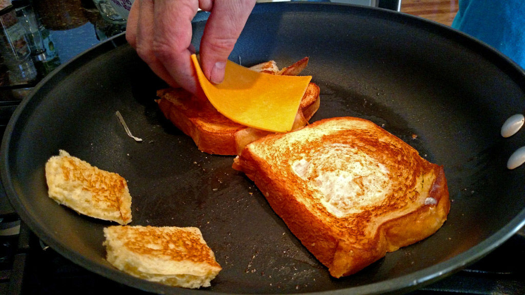 Eggs in a basket is a quick and easy breakfast, these eggs are fried inside a hole cut into a slice of bread and topped with melted cheese. | TheMountainKitchen.com