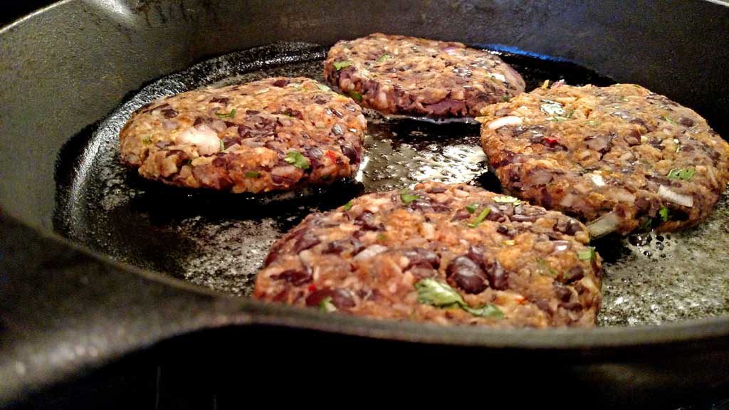 frying black bean burgers in cast iron pan