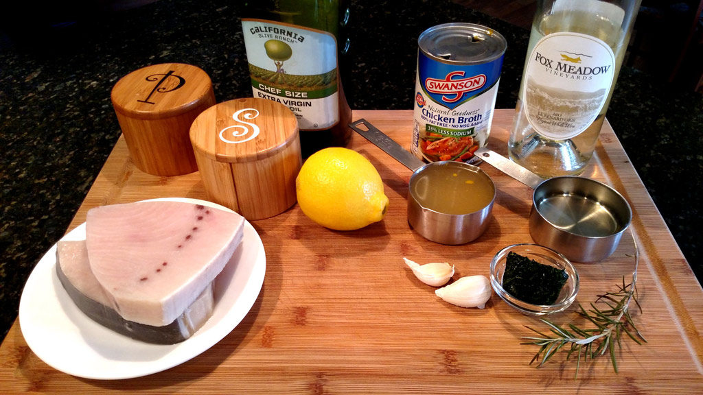 Sexy swordfish fillets smothered in a wonderful zesty sauce made of white wine, chicken broth, and garlic then finished off with lemon and fresh herbs. | TheMountainKitchen.com