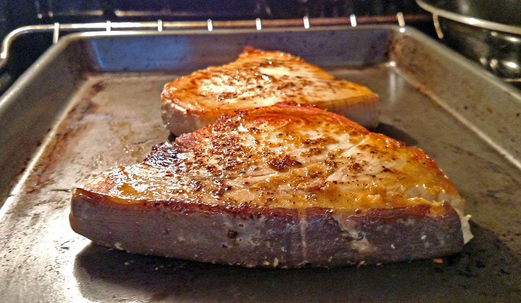 Sexy swordfish fillets smothered in a wonderful zesty sauce made of white wine, chicken broth, and garlic then finished off with lemon and fresh herbs. | TheMountainKitchen.com