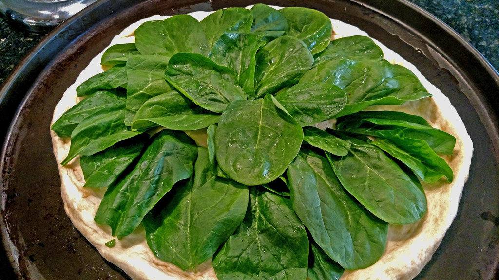spinach topping pizza dough