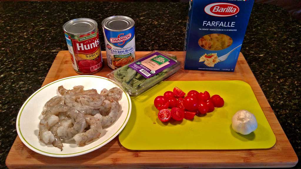 Basil, garlic, broth and tomato sauce all come together to create a delicious light sauce over Farfalle noodles and plump shrimp for this Shrimp Pomodoro. | TheMountainKitchen.com