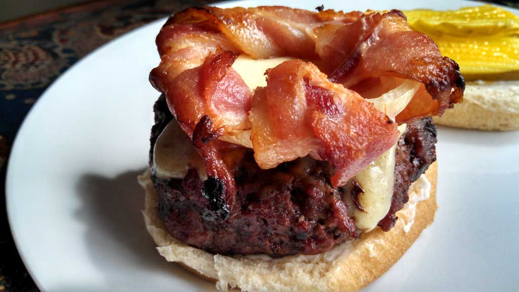burger topped with bacon-wrapped onion