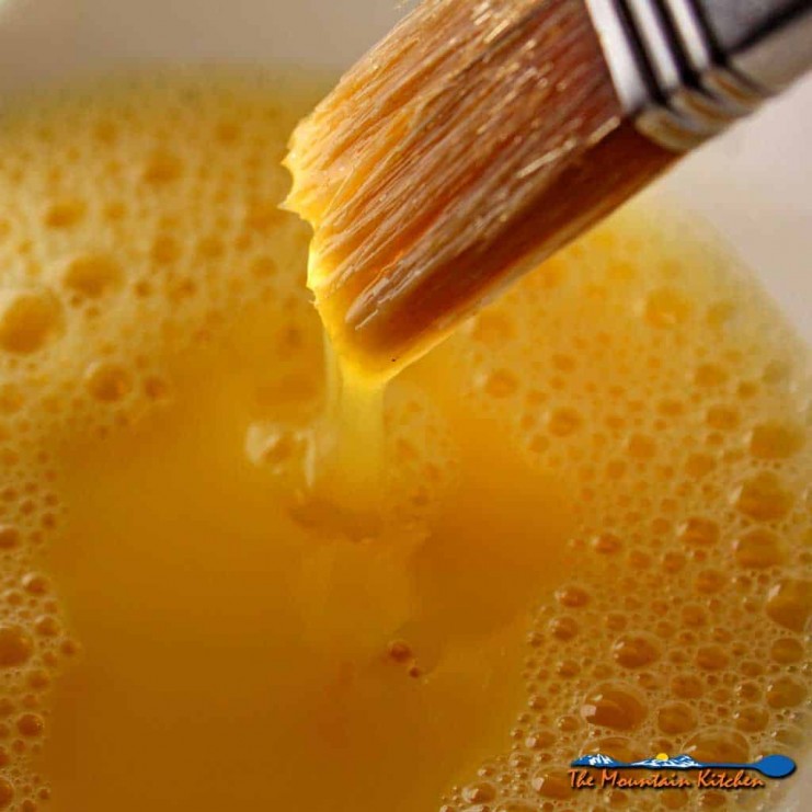 In the culinary arts, the term Egg Wash refers to a mixture of beaten eggs and some sort of liquid which is brushed pastry, before baking. | TheMountainKitchen.com