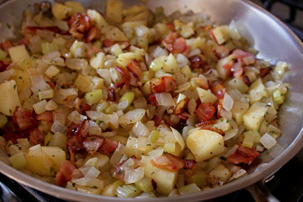 apples, bacon, onion and celery in oven-safe skillet