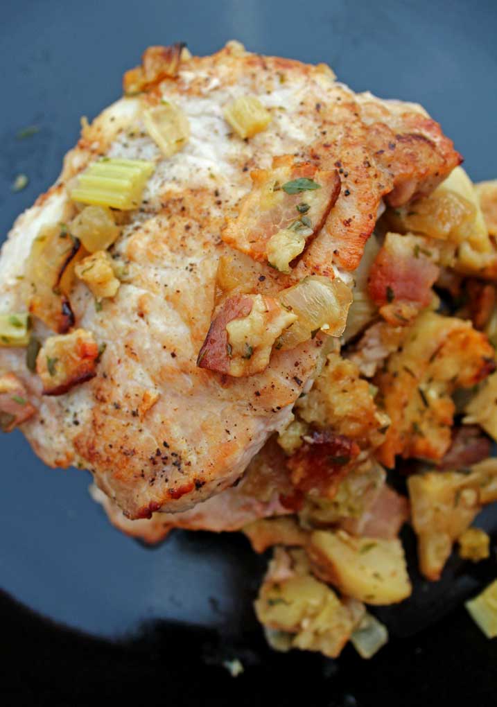 pork chops with apple-bacon stuffing on plate